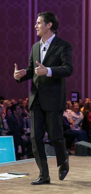 Patrick Combs on stage giving a motivational keynote