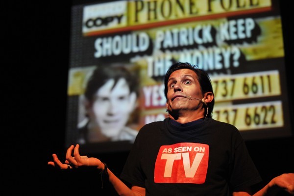 Patrick Combs on stage during Man 1, Bank 0 — the phone poll moment