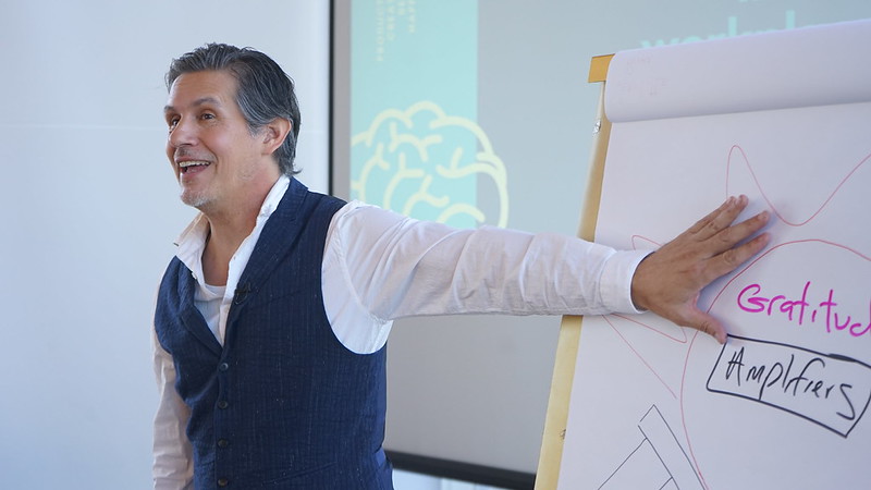 Patrick Combs working with a client at the flip chart during a coaching immersive